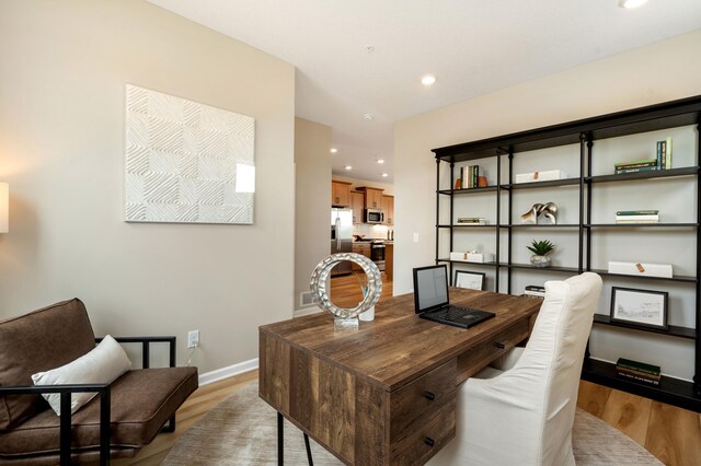 6758 Wildflower Way, Minnetrista, MN 55331 - home office with light wood-style floors, recessed lighting, and baseboards
