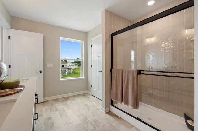 6758 Wildflower Way, Minnetrista, MN 55331 - full bathroom with a stall shower, baseboards, double vanity, and recessed lighting