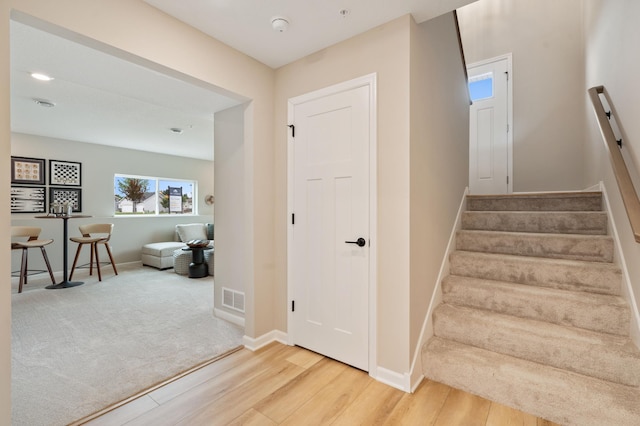 6758 Wildflower Way, Minnetrista, MN 55331 - stairs with wood finished floors and baseboards
