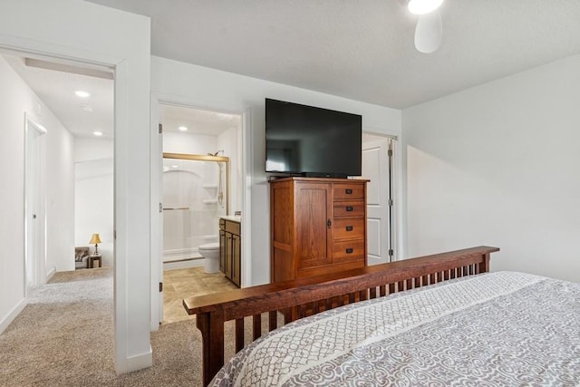 bedroom featuring light carpet and connected bathroom
