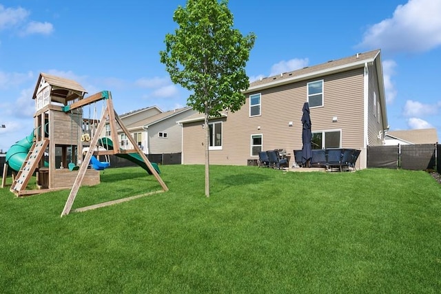 back of house with a playground