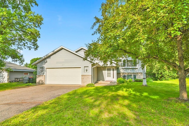 204 10th Ave N, Cold Spring, MN 56320 - view of front facade featuring asphalt driveway, a garage, brick siding, and a front yard