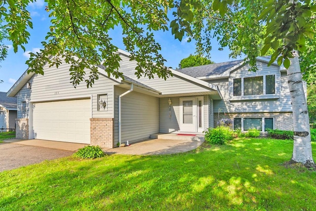 204 10th Ave N, Cold Spring, MN 56320 - split level home featuring brick siding, an attached garage, a front lawn, and driveway