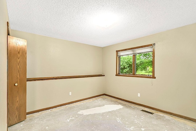 204 10th Ave N, Cold Spring, MN 56320 - spare room featuring a textured ceiling and unfinished concrete floors