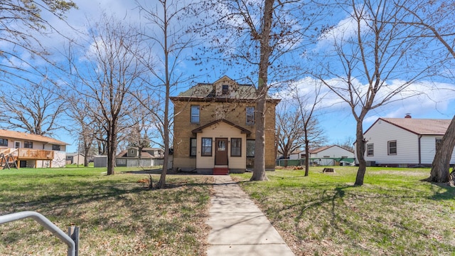 view of front facade with a front lawn, fence, and a residential view