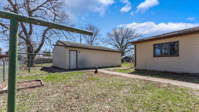 exterior space featuring fence and an outbuilding