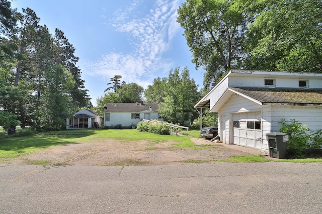 203 Main St, Crosby, MN 56441 - view of front of property featuring a garage, a front yard, and driveway