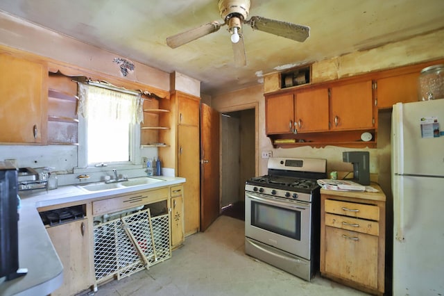 203 Main St, Crosby, MN 56441 - kitchen with freestanding refrigerator, stainless steel range with gas cooktop, open shelves, a ceiling fan, and light countertops