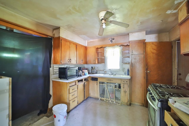 203 Main St, Crosby, MN 56441 - kitchen featuring stainless steel range with gas cooktop, open shelves, ceiling fan, light countertops, and brown cabinets