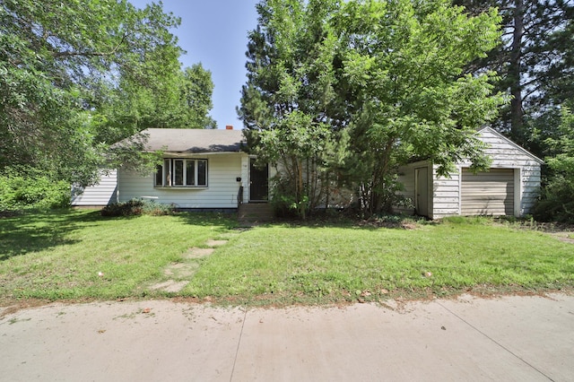 203 Main St, Crosby, MN 56441 - view of front of house with a garage, a front lawn, driveway, and an outbuilding