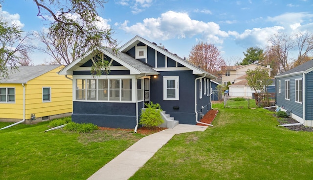back of property featuring a lawn, fence, and stucco siding