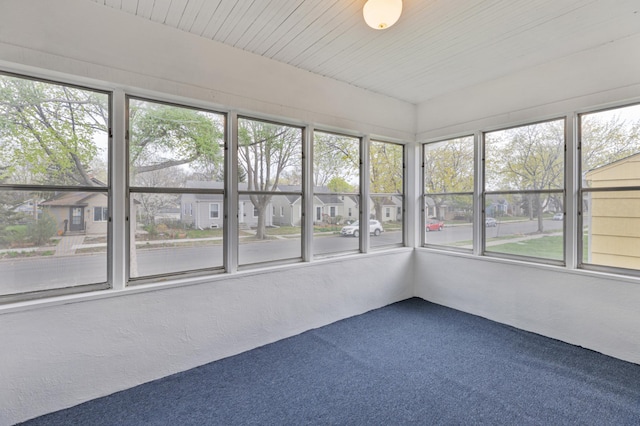 unfurnished sunroom featuring carpet flooring