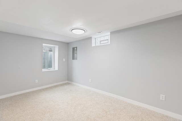 carpeted spare room featuring baseboards, a healthy amount of sunlight, and visible vents