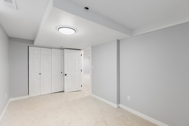 unfurnished bedroom featuring carpet floors, baseboards, visible vents, and a closet