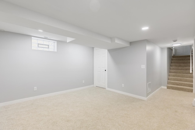 basement with visible vents, light carpet, baseboards, stairway, and recessed lighting