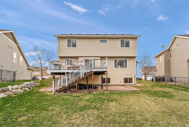 back of property featuring stairs, a patio area, a wooden deck, and a yard
