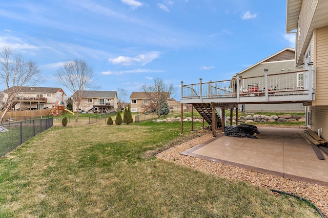 view of yard with a residential view, stairs, a wooden deck, a fenced backyard, and a patio