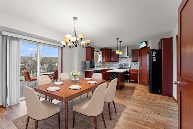 dining room featuring an inviting chandelier and light wood finished floors