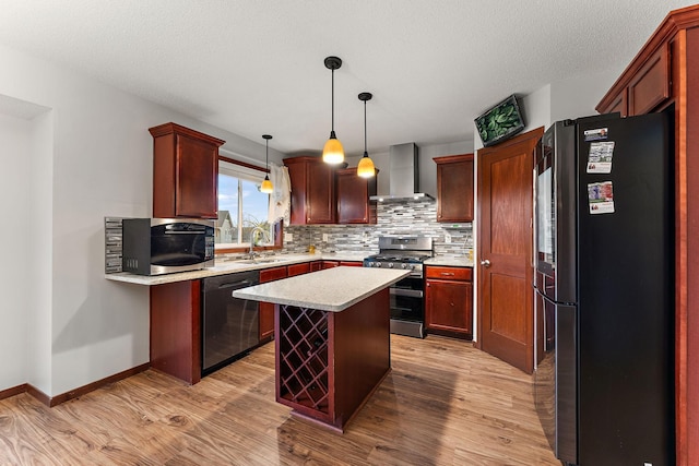 kitchen featuring decorative backsplash, light countertops, light wood finished floors, stainless steel appliances, and wall chimney exhaust hood