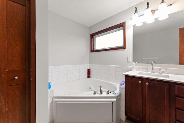 full bathroom featuring a whirlpool tub and vanity