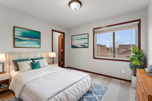 bedroom with baseboards and visible vents