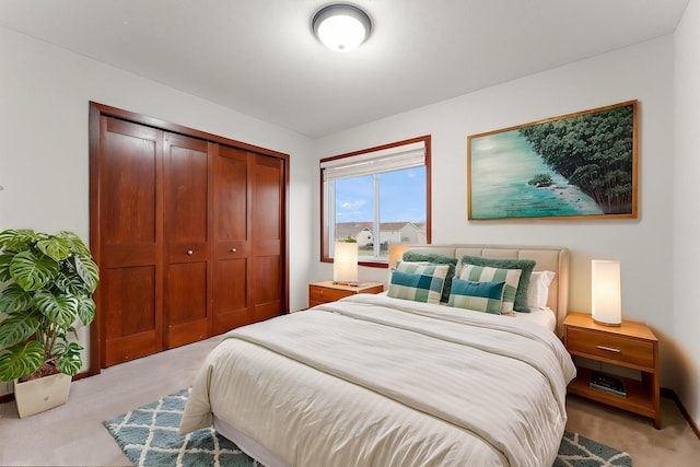 bedroom featuring a closet and light carpet