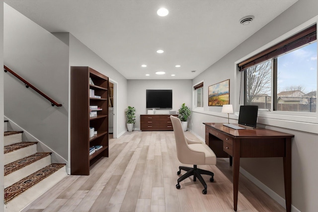 office area with baseboards, light wood finished floors, recessed lighting, and visible vents