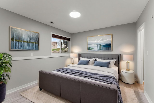 bedroom featuring baseboards and light wood-type flooring