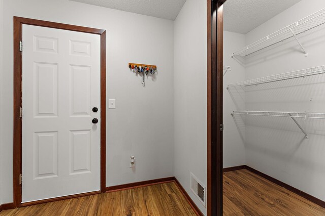 16268 Tahinka Ct NW, Prior Lake, MN 55372 - foyer featuring wood finished floors, baseboards, and a textured ceiling