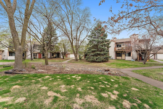 2071 Parkside Dr Unit 30, Saint Paul, MN 55119 - view of community featuring a garage, a lawn, and a deck