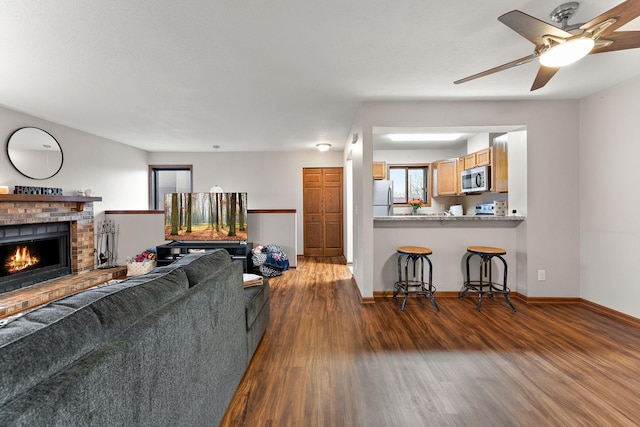 2071 Parkside Dr Unit 30, Saint Paul, MN 55119 - living room with dark wood finished floors, a brick fireplace, baseboards, and ceiling fan
