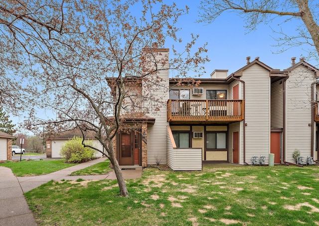 2071 Parkside Dr Unit 30, Saint Paul, MN 55119 - back of house with a yard, a wooden deck, and a chimney