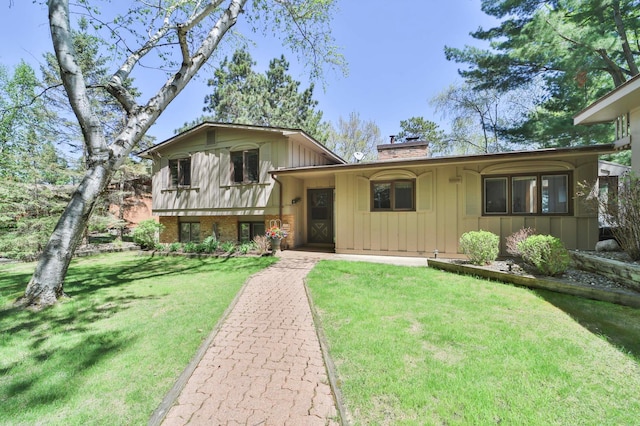 2072 Bluebill Ln SW, Nisswa, MN 56468 - split level home with a chimney, board and batten siding, and a front lawn