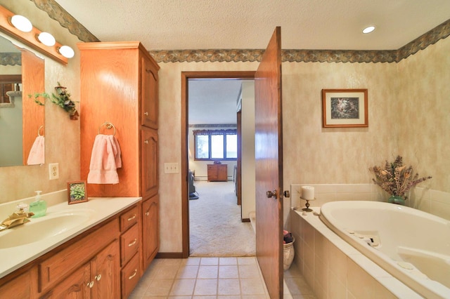 2072 Bluebill Ln SW, Nisswa, MN 56468 - bathroom featuring a tub with jets, tile patterned floors, vanity, and a textured ceiling