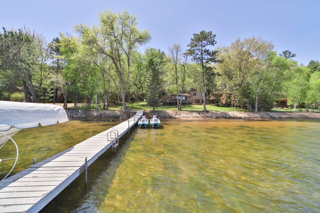 2072 Bluebill Ln SW, Nisswa, MN 56468 - dock featuring a yard, view of scattered trees, and a water view
