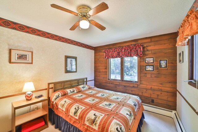 2072 Bluebill Ln SW, Nisswa, MN 56468 - bedroom with light colored carpet, wood walls, ceiling fan, and a baseboard radiator