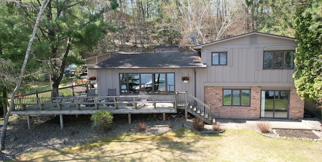 2072 Bluebill Ln SW, Nisswa, MN 56468 - back of property featuring brick siding, a yard, a deck, and roof with shingles