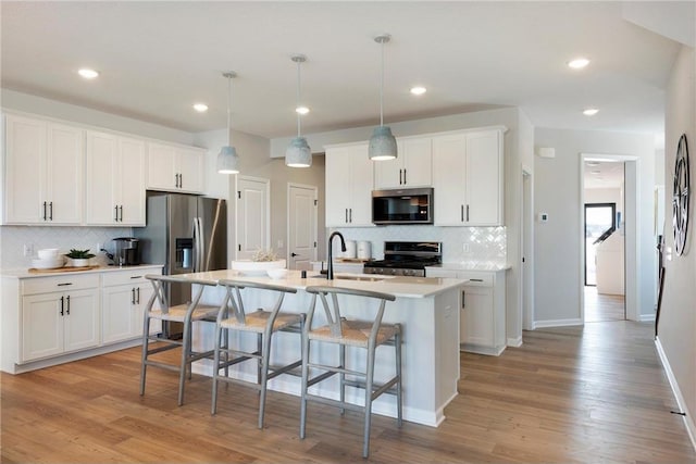 1763 Hauer Trl, Shakopee, MN 55379 - kitchen featuring stainless steel appliances, a sink, backsplash, a center island with sink, and recessed lighting