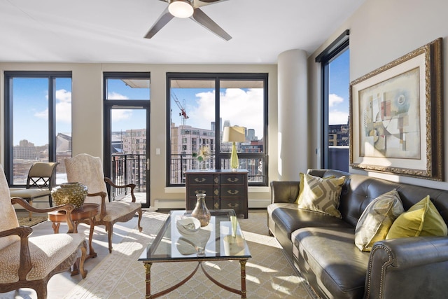 living area featuring a ceiling fan, a baseboard radiator, and a city view
