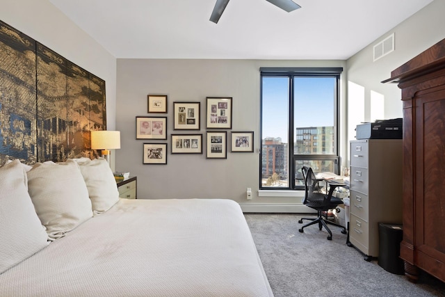carpeted bedroom with ceiling fan, visible vents, and a baseboard radiator