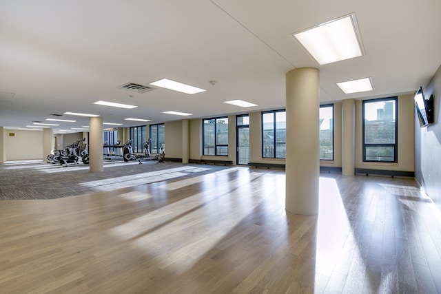 interior space featuring expansive windows, visible vents, and wood finished floors