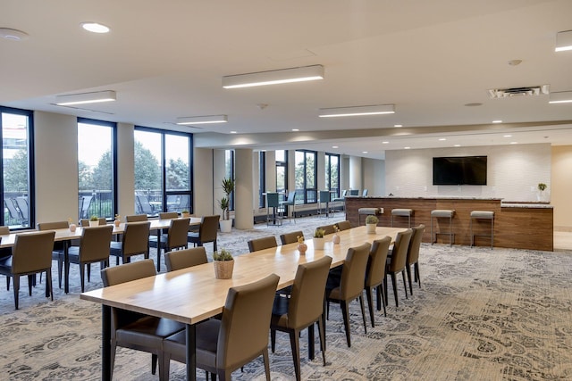 dining area with visible vents, recessed lighting, expansive windows, and light colored carpet