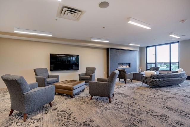 carpeted living area featuring visible vents and a fireplace