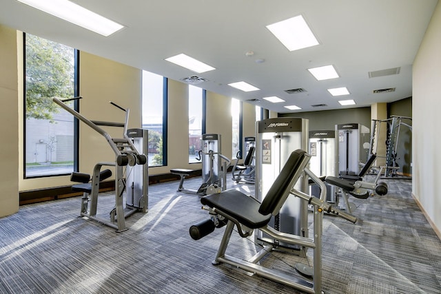 exercise room with visible vents and carpet flooring