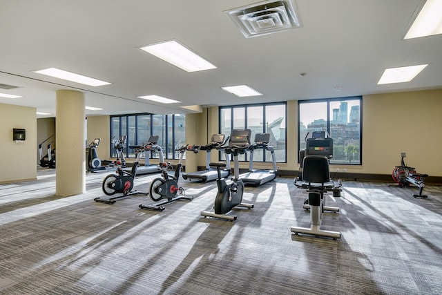 workout area featuring carpet floors, baseboards, and visible vents