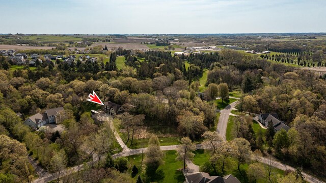 aerial view of property's location featuring a forest