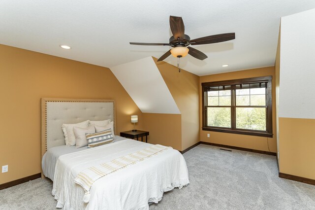 carpeted bedroom with baseboards, recessed lighting, ceiling fan, and vaulted ceiling