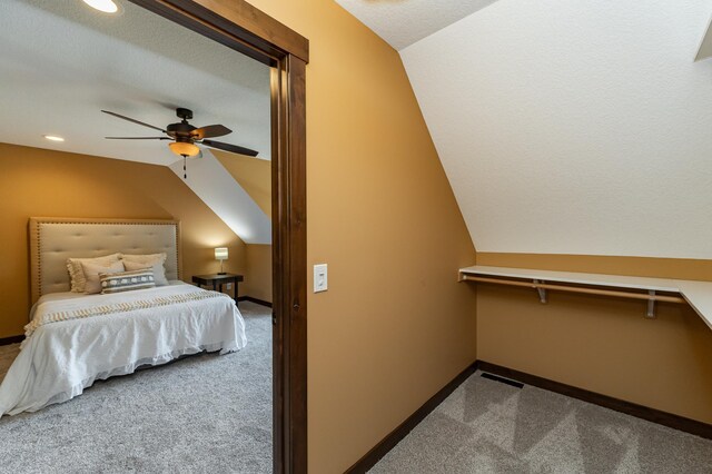 carpeted bedroom featuring lofted ceiling, baseboards, a ceiling fan, and recessed lighting
