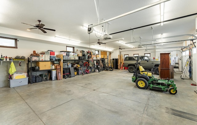garage with a garage door opener and a ceiling fan