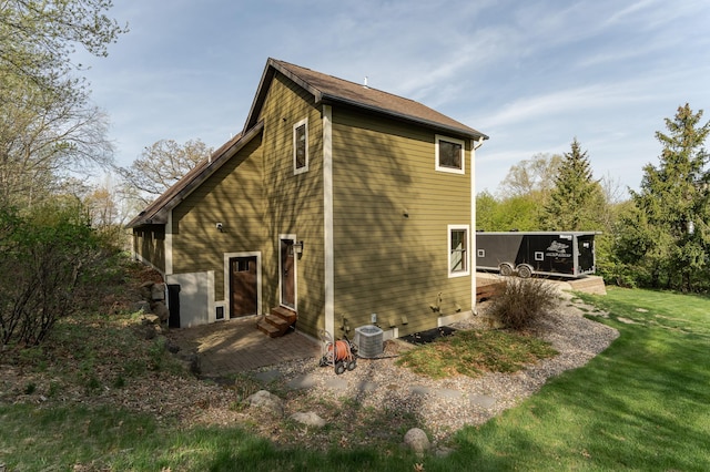 17361 Sugarloaf Pkwy, Minneola Twp, MN 55992 - back of property with central AC unit, a yard, a deck, a patio, and entry steps